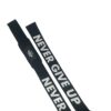 Slim Gym lifting straps laid flat with 'Never Give Up' motto for motivation