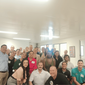 Group photo of attendees at the end of the networking event, smiling and looking satisfied with the day’s outcomes.