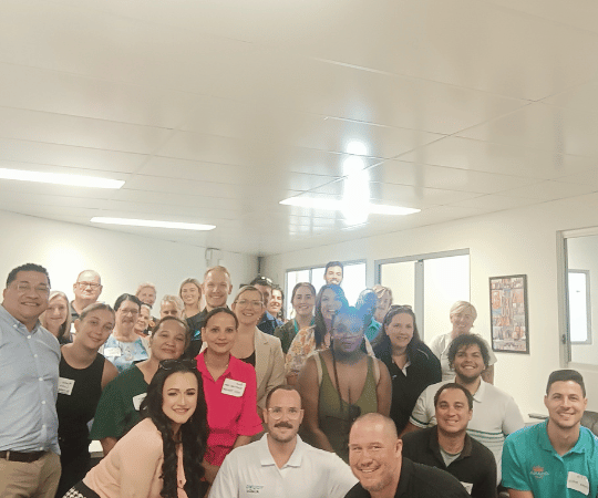 Group photo of attendees at the end of the networking event, smiling and looking satisfied with the day’s outcomes.