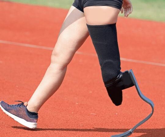 Runner with a prosthetic leg on a track during training